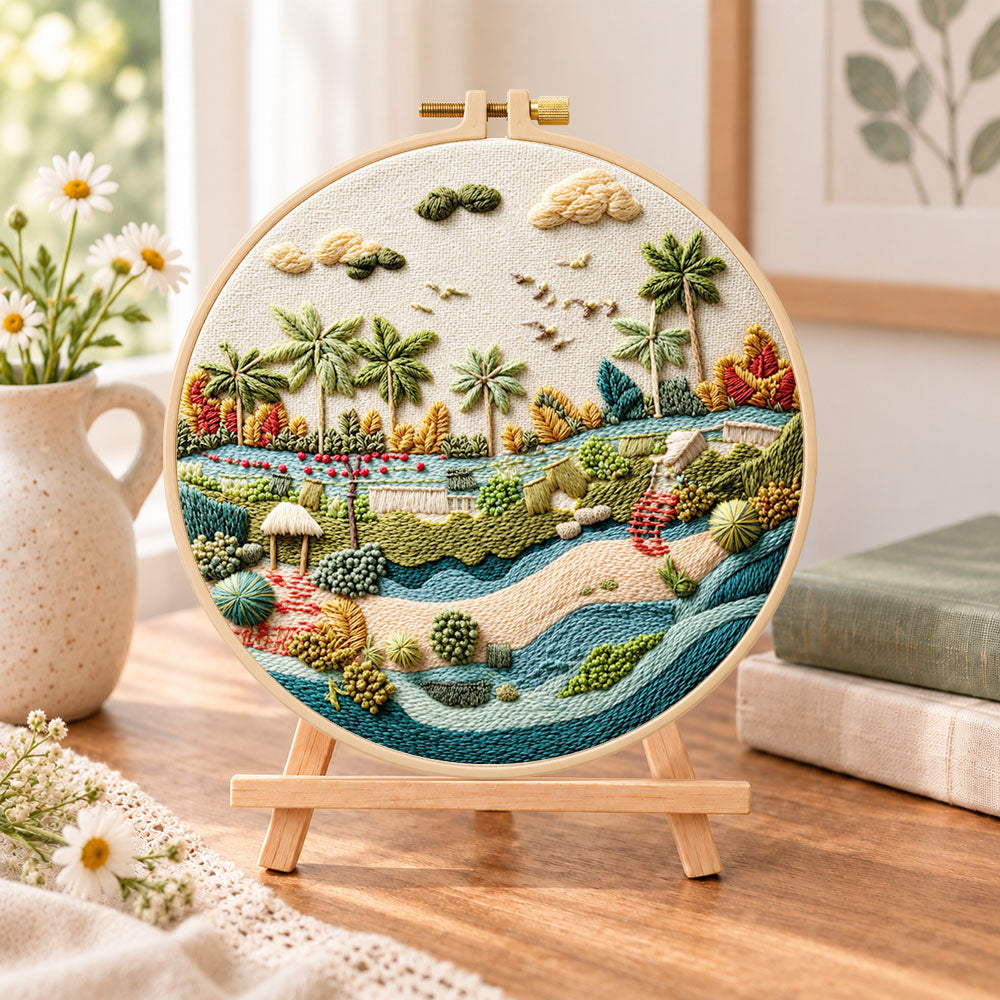 Quiet riverside tropics embroidery kit finished hoop displayed on a wooden stand as cozy tabletop decor