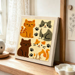 Quirky multi-colored kitty punch needle artwork displayed on a table