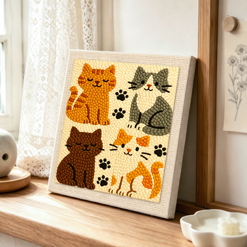 Quirky multi-colored kitty punch needle artwork displayed on a table