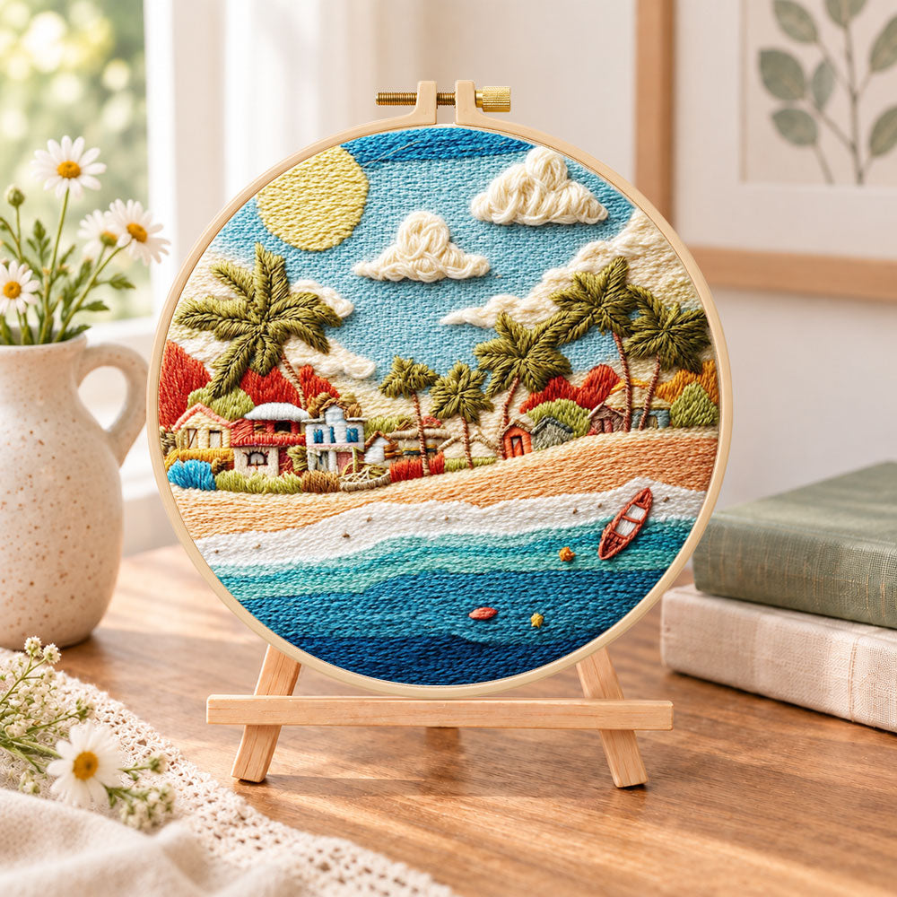 Radiant coastal hamlet embroidery kit finished hoop displayed on a wooden stand as cozy tabletop decor