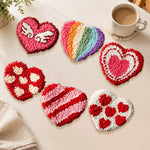 Rainbow and winged heart punch needle coasters used for home decoration