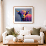 Finished rainbow highland cow cross stitch artwork displayed as home decor