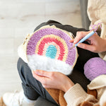 Creating handmade rainbow over clouds punch needle artwork