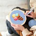 Creating handmade rainbow scoop ice cream cone punch needle artwork