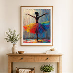 Finished rainbow tutu dancer cross stitch artwork displayed as home decor