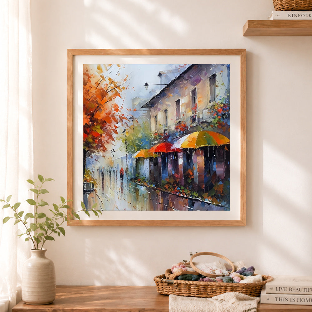 Finished rainy autumn street with colorful umbrellas cross stitch artwork displayed as home decor