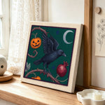 Raven and harvest pumpkin punch needle artwork displayed on a table