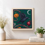 Finished raven and harvest pumpkin artwork displayed on a wall