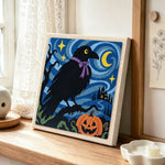 Raven with halloween night punch needle artwork displayed on a table