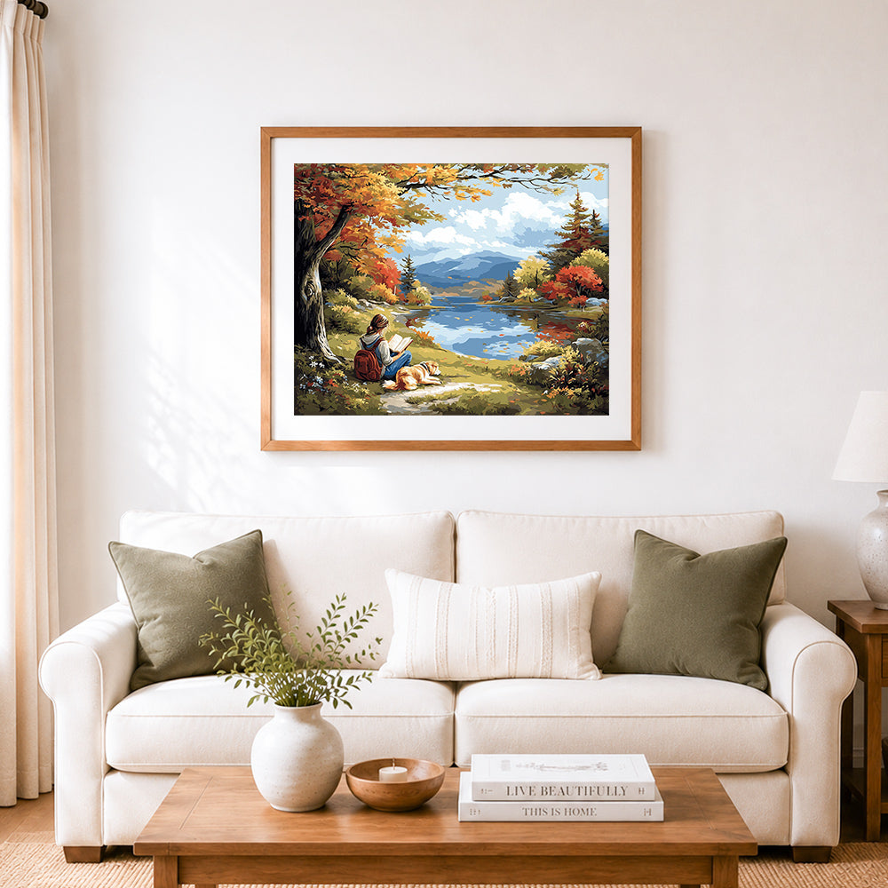 Finished reading beside autumn lake cross stitch artwork displayed as home decor