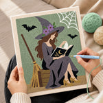 Creating handmade reading witch with spell book punch needle artwork