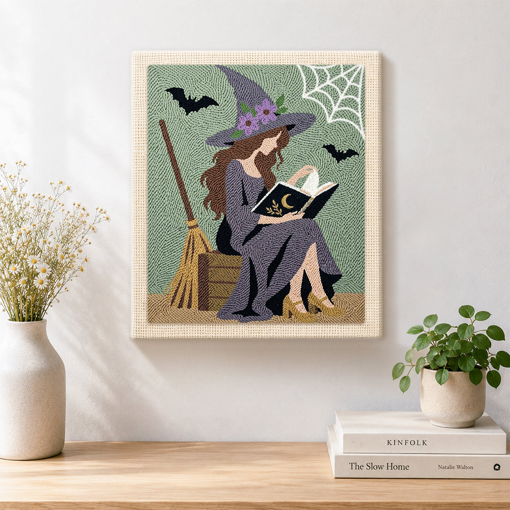 Finished reading witch with spell book artwork displayed on a wall