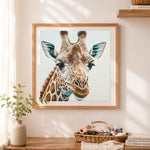 Finished realistic giraffe portrait cross stitch artwork displayed as home decor