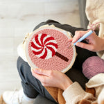 Creating handmade red and white swirl lollipop unch needle artwork
