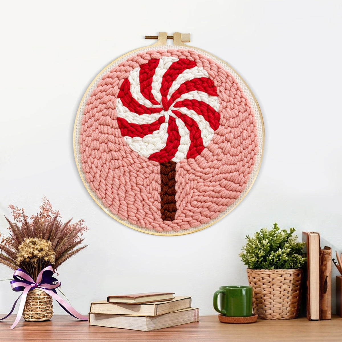 Finished red and white swirl lollipop artwork displayed on a wall