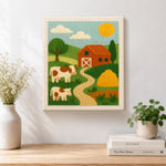 Finished red barn and cows landscape artwork displayed on a wall