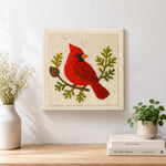 Finished red cardinal on a branch artwork displayed on a wall