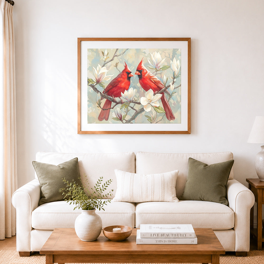 Finished red cardinals on magnolia branches cross stitch artwork displayed as home decor