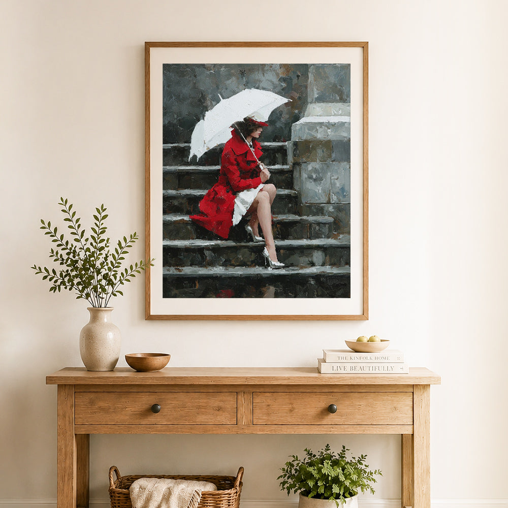 Finished red coat in rain cross stitch artwork displayed as home decor