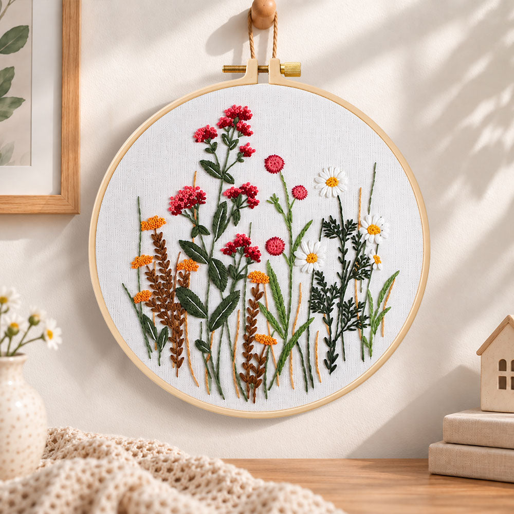 Red wildflower bouquet embroidery hoop wall art displayed as warm and cozy handmade home decor