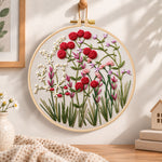 Red wildflower patch embroidery hoop wall art displayed as warm and cozy handmade home decor
