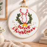 Reindeer and christmas text embroidery hoop wall art displayed as warm and cozy handmade home decor