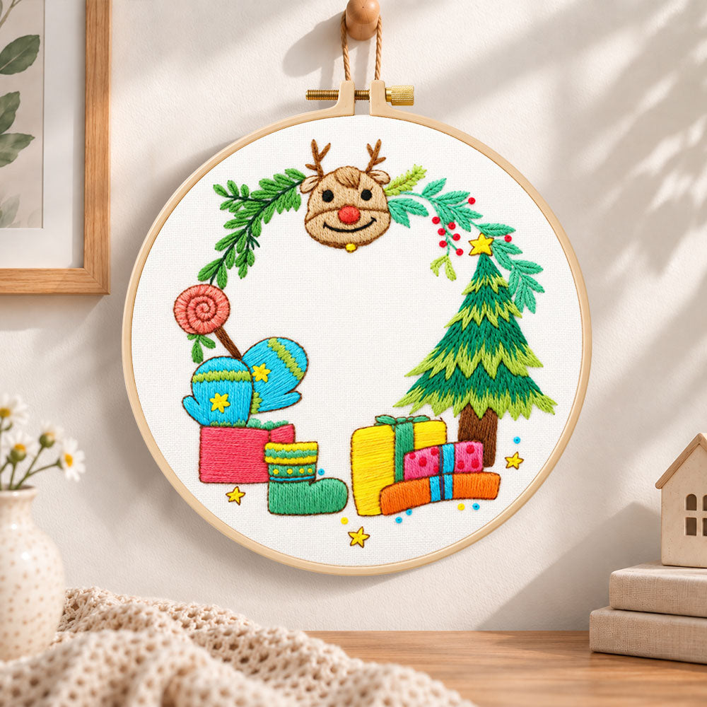 Reindeer and gifts scene embroidery hoop wall art displayed as warm and cozy handmade home decor