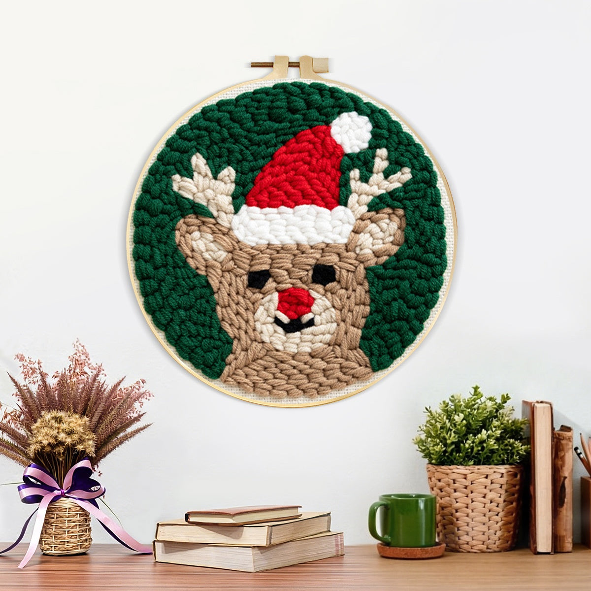Finished reindeer with santa hat artwork displayed on a wall