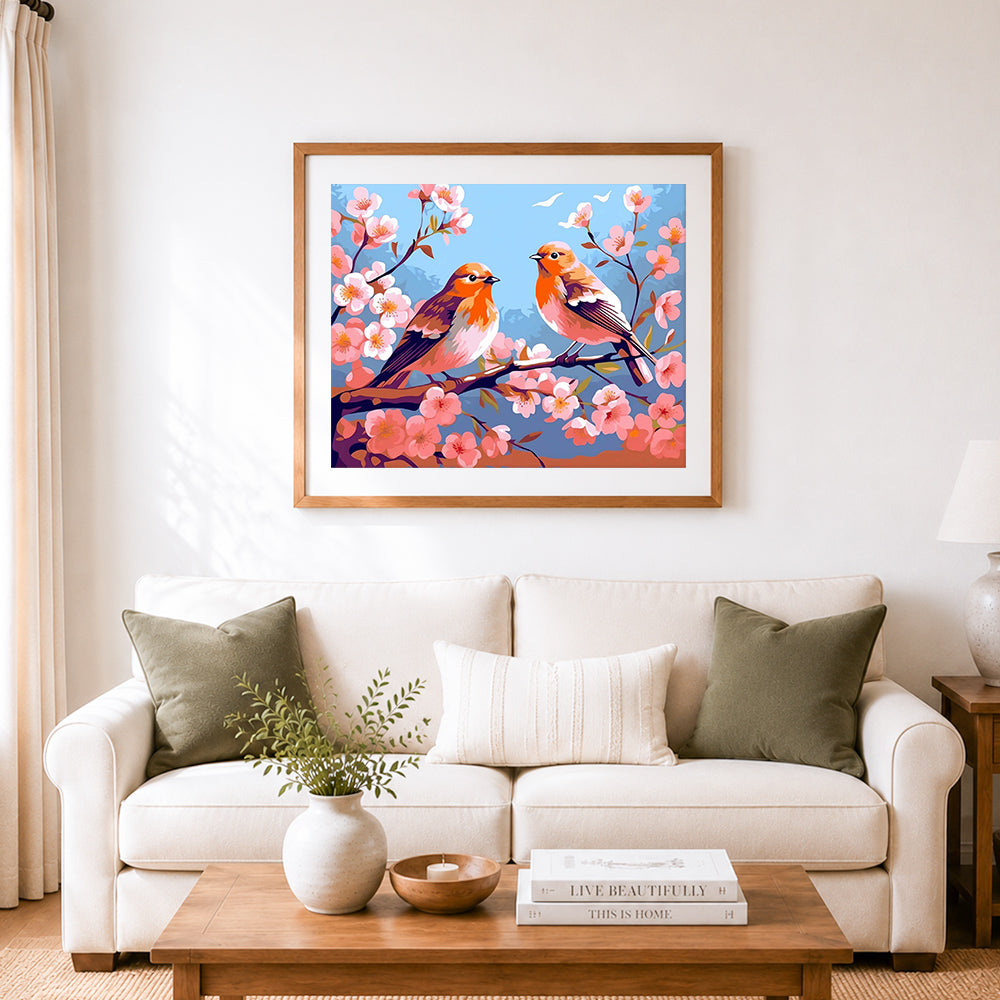 Finished robins among spring blossoms cross stitch artwork displayed as home decor