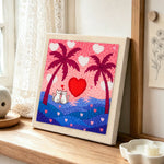 Romantic cat couple, heart sunset and palm trees punch needle artwork displayed on a table