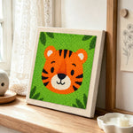 Round and cuddly tiger face punch needle artwork displayed on a table