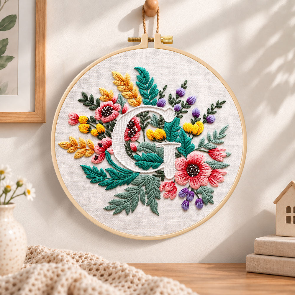 Rustic floral mix and letter g embroidery hoop wall art displayed as warm and cozy handmade home decor