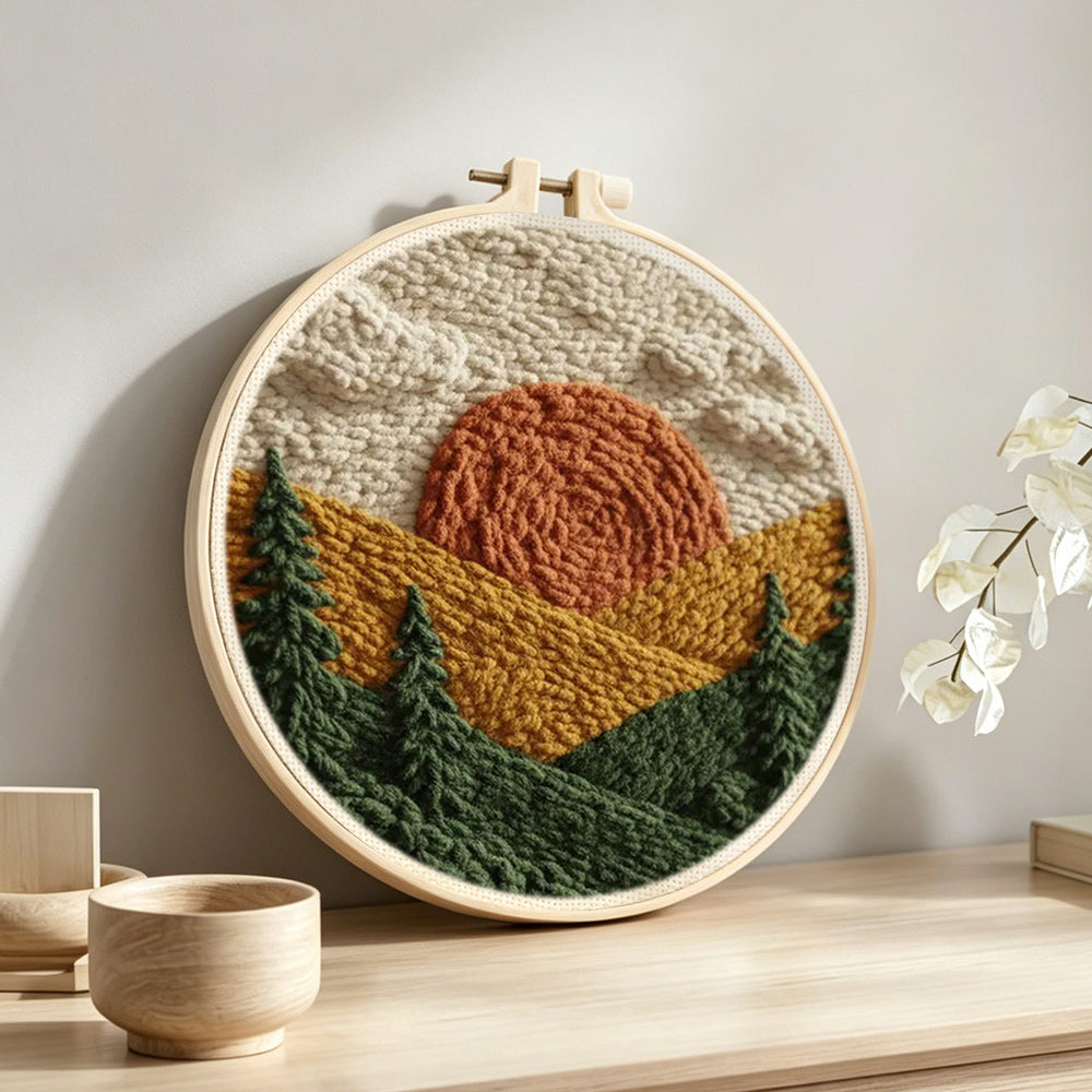 Rustic pine forest sunset punch needle artwork displayed on a table