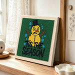 Sad melting snowman art punch needle artwork displayed on a table