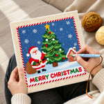 Creating handmade santa beside christmas tree punch needle artwork