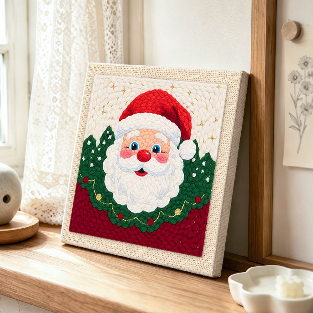 Santa claus portrait punch needle artwork displayed on a table