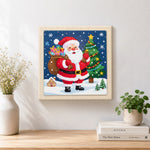 Finished santa claus with gift sack artwork displayed on a wall