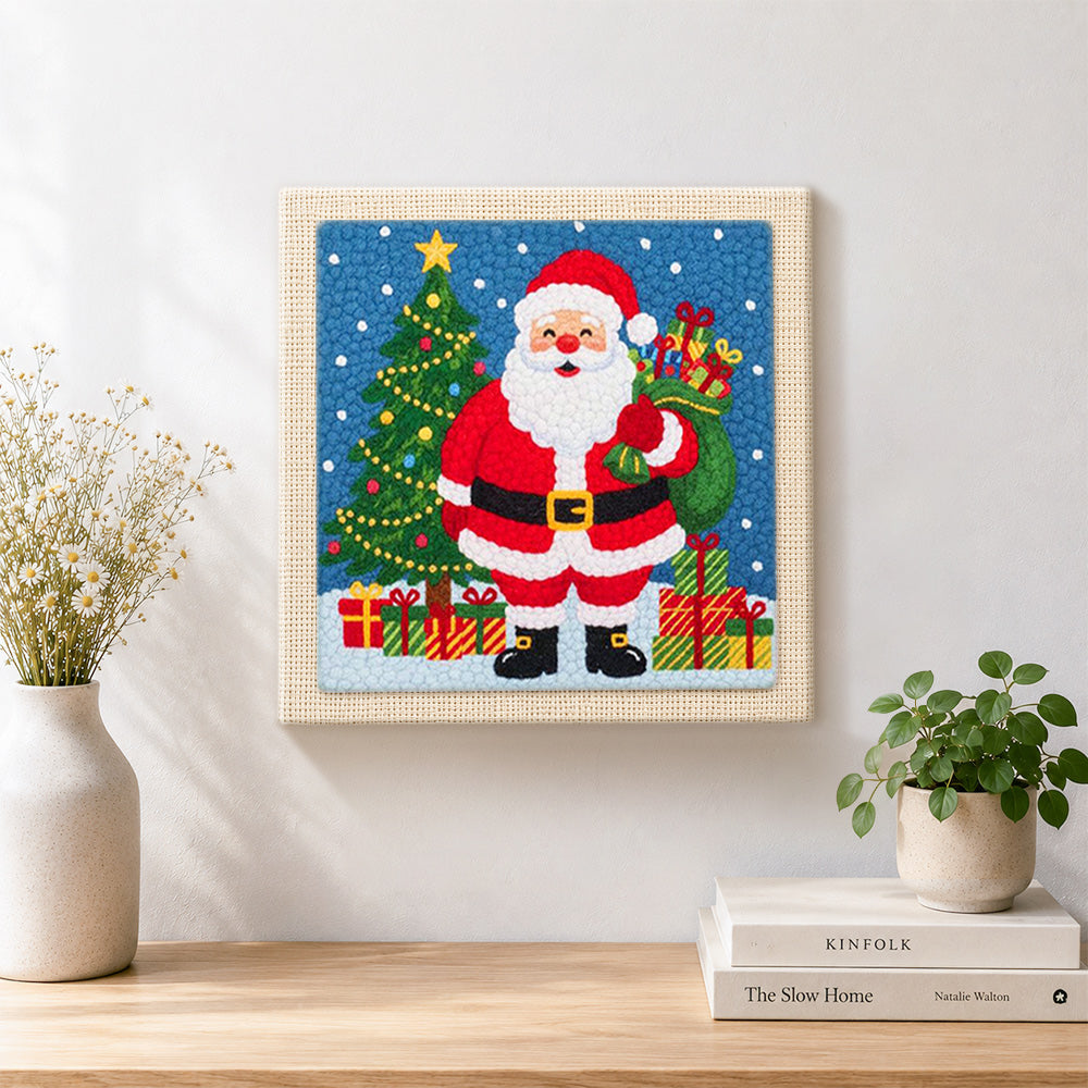 Finished santa holding gift sack artwork displayed on a wall