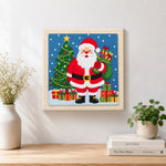 Finished santa holding gift sack artwork displayed on a wall