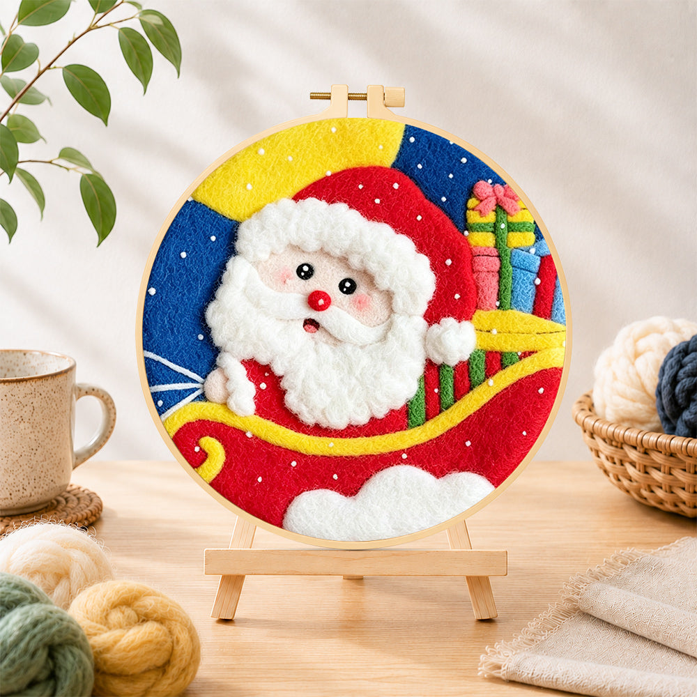 Finished santa in sleigh with gifts needle felting displayed on a wooden easel
