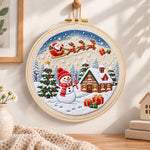 Santa sleigh winter village embroidery hoop wall art displayed as warm and cozy handmade home decor