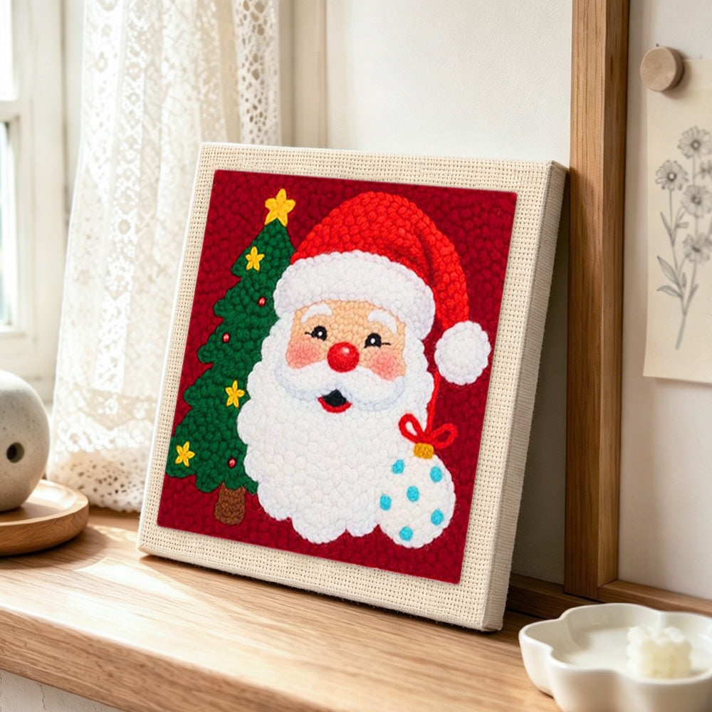 Santa with christmas tree punch needle artwork displayed on a table