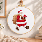 Santa with gift sack embroidery hoop wall art displayed as warm and cozy handmade home decor