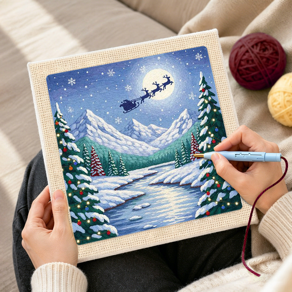 Creating handmade santa’s sleigh over snow peaks punch needle artwork