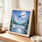 Santa’s sleigh over snow peaks punch needle artwork displayed on a table