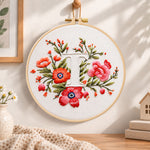 Scarlet florals and letter t embroidery hoop wall art displayed as warm and cozy handmade home decor