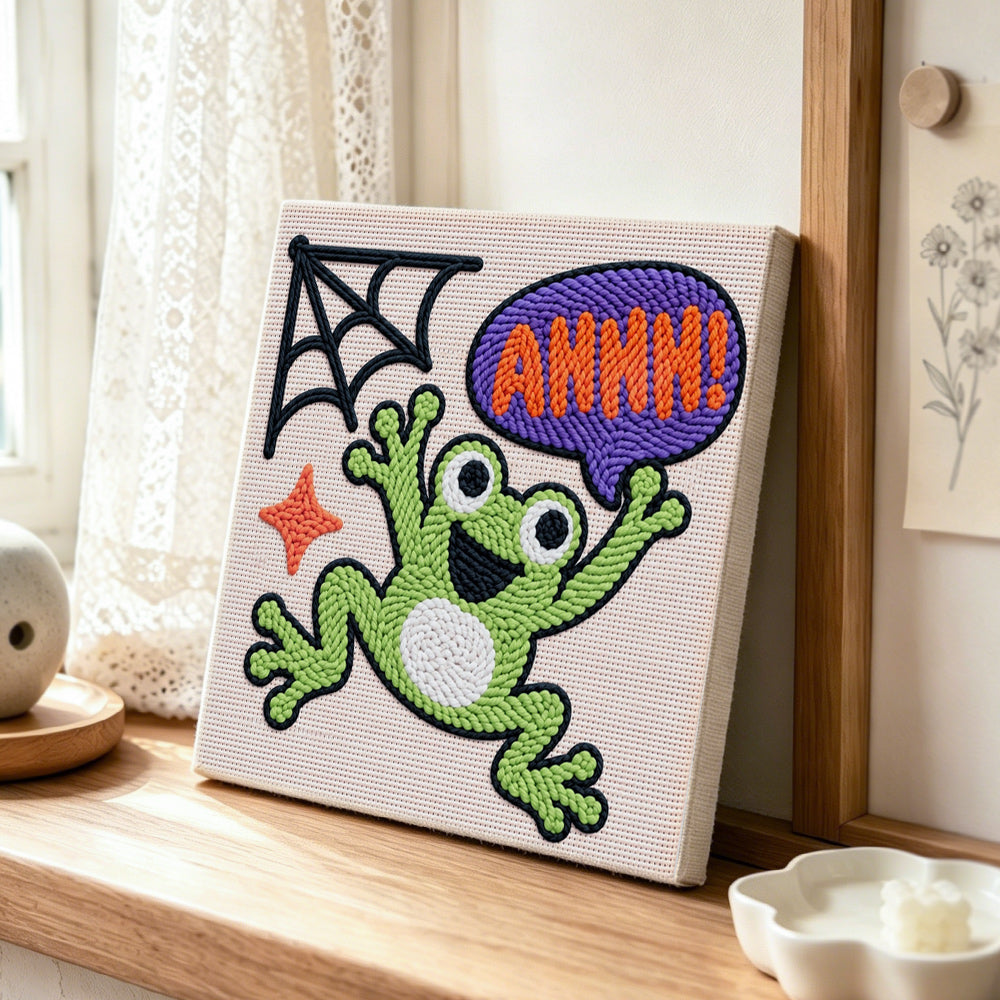 Screaming halloween frog punch needle artwork displayed on a table