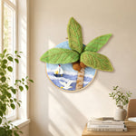 Seagull, palm tree and sailboat needle felt wall art displayed in a bright home interior