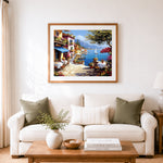 Finished seaside cafe with blue water view cross stitch artwork displayed as home decor
