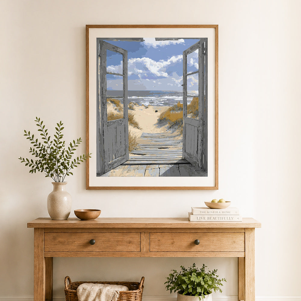 Finished seaside window view cross stitch artwork displayed as home decor